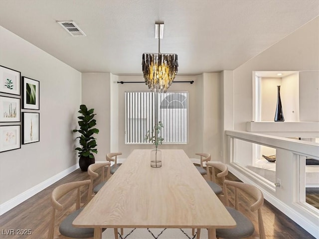 6639 Tranquil Seas Ct, Las Vegas, NV 89139 - dining space featuring a chandelier, dark wood-style flooring, and baseboards