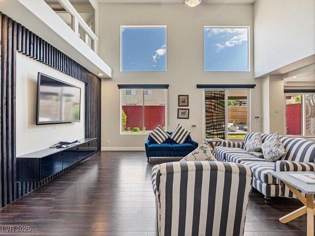 6639 Tranquil Seas Ct, Las Vegas, NV 89139 - living area featuring a towering ceiling, baseboards, and dark wood-style floors