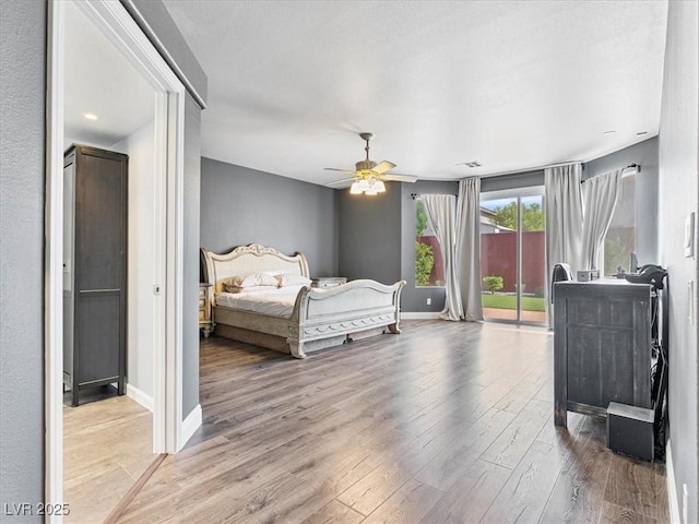 6639 Tranquil Seas Ct, Las Vegas, NV 89139 - bedroom featuring access to exterior, wood finished floors, baseboards, and a ceiling fan