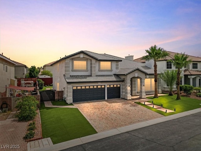 6639 Tranquil Seas Ct, Las Vegas, NV 89139 - view of front of home featuring decorative driveway, an attached garage, stucco siding, and a tile roof
