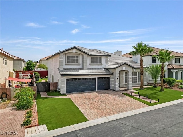 6639 Tranquil Seas Ct, Las Vegas, NV 89139 - view of front facade featuring stucco siding, decorative driveway, a garage, and a tiled roof