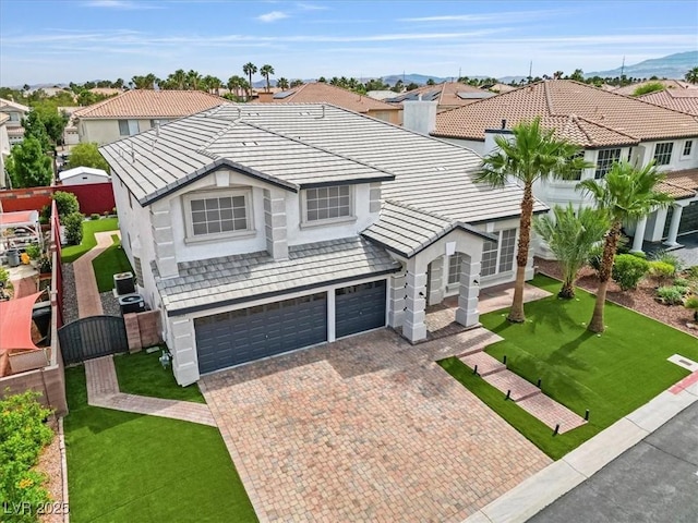 6639 Tranquil Seas Ct, Las Vegas, NV 89139 - view of front facade with a garage, decorative driveway, stucco siding, a tiled roof, and a residential view