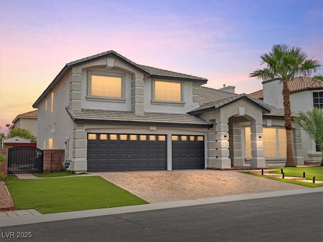 6639 Tranquil Seas Ct, Las Vegas, NV 89139 - view of front of house featuring a gate, stucco siding, a tile roof, an attached garage, and decorative driveway