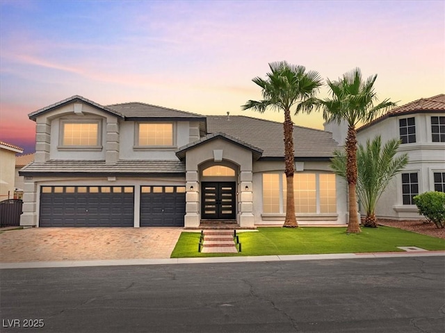 6639 Tranquil Seas Ct, Las Vegas, NV 89139 - view of front facade featuring french doors, a garage, stucco siding, driveway, and a tile roof