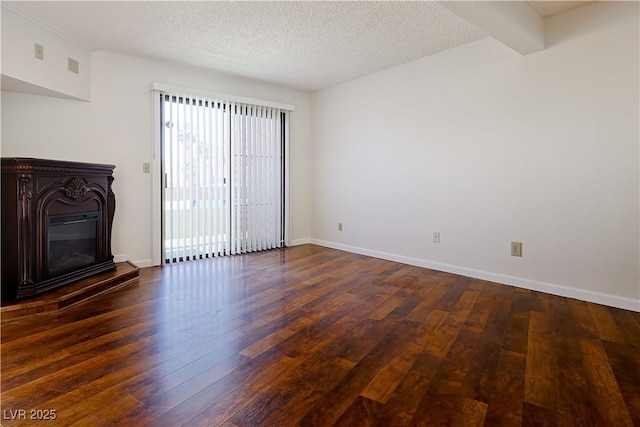 3811 Desert Marina Dr Unit 125, Laughlin, NV 89029 - unfurnished living room with a glass covered fireplace, hardwood / wood-style floors, a textured ceiling, and baseboards