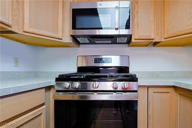 3811 Desert Marina Dr Unit 125, Laughlin, NV 89029 - kitchen with stainless steel appliances, light brown cabinets, and light countertops