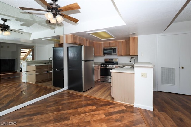 3811 Desert Marina Dr Unit 125, Laughlin, NV 89029 - kitchen featuring appliances with stainless steel finishes, a sink, ceiling fan, dark wood-type flooring, and light countertops