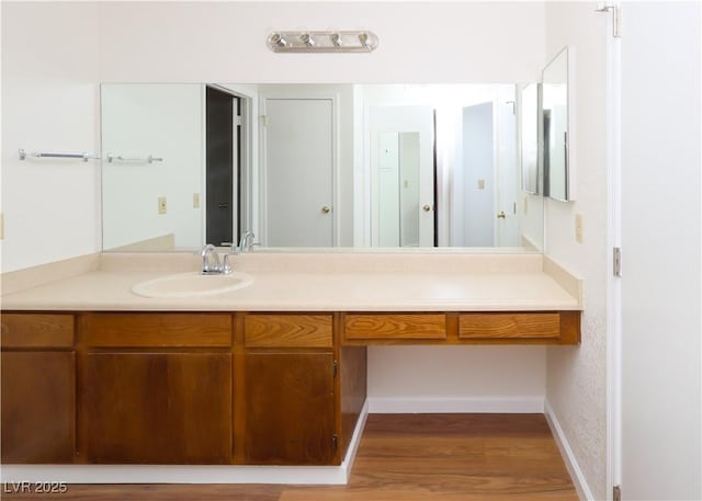 3811 Desert Marina Dr Unit 125, Laughlin, NV 89029 - bathroom with vanity, wood finished floors, and baseboards