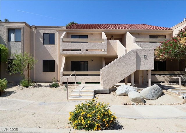 3811 Desert Marina Dr Unit 125, Laughlin, NV 89029 - back of house with stucco siding, a balcony, and a tile roof