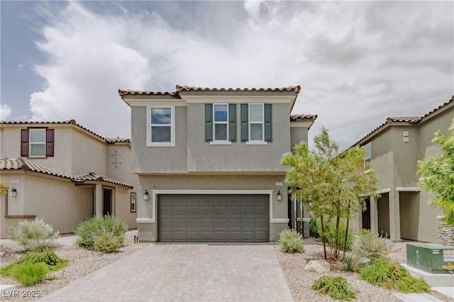 5927 Coja St, Las Vegas, NV 89113 - mediterranean / spanish-style house featuring stucco siding, decorative driveway, an attached garage, and a tile roof