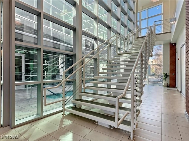 38 E Serene Ave Unit 134, Las Vegas, NV 89123 - stairs with tile patterned floors, healthy amount of natural light, and a high ceiling