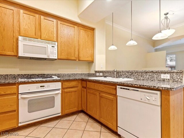 38 E Serene Ave Unit 134, Las Vegas, NV 89123 - kitchen with white appliances, a sink, a peninsula, crown molding, and light tile patterned flooring