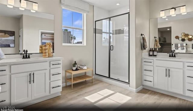 2615 Regency Cove Ct Lot 13, Las Vegas, NV 89121 - bathroom with wood finished floors, a stall shower, two vanities, and recessed lighting