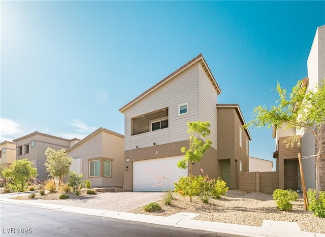 9934 Iron Creek Ave, Las Vegas, NV 89178 - view of front of property featuring an attached garage, driveway, and stucco siding