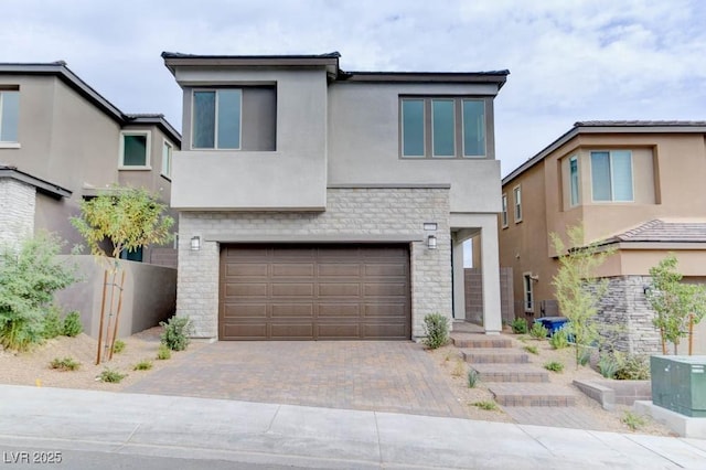 11840 Pelican Butte Ave, Las Vegas, NV 89138 - contemporary house with stucco siding, decorative driveway, an attached garage, and stone siding