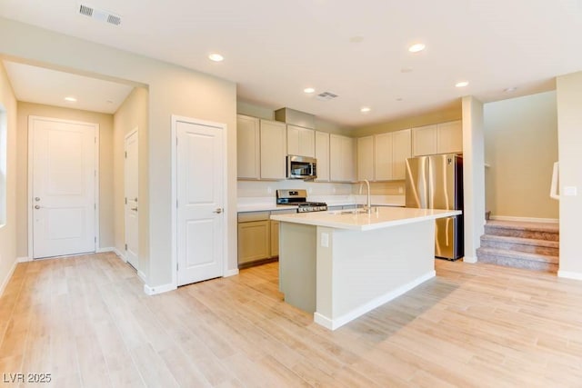 11840 Pelican Butte Ave, Las Vegas, NV 89138 - kitchen with appliances with stainless steel finishes, a sink, an island with sink, light countertops, and baseboards