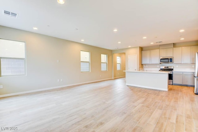 11840 Pelican Butte Ave, Las Vegas, NV 89138 - kitchen with stainless steel appliances, a sink, open floor plan, recessed lighting, and light countertops