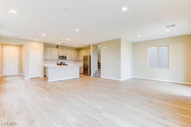 11840 Pelican Butte Ave, Las Vegas, NV 89138 - unfurnished living room with baseboards, light wood-type flooring, recessed lighting, and stairs