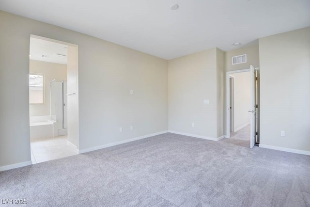 11840 Pelican Butte Ave, Las Vegas, NV 89138 - unfurnished bedroom featuring light carpet, baseboards, and ensuite bath