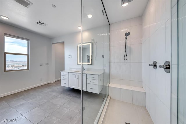 1038 Delbrook Ave, Henderson, NV 89012 - bathroom featuring vanity, a tile shower, tile patterned flooring, and baseboards