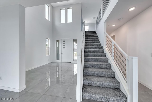 1038 Delbrook Ave, Henderson, NV 89012 - staircase with baseboards, healthy amount of natural light, and a high ceiling