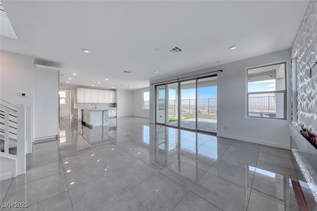 1038 Delbrook Ave, Henderson, NV 89012 - unfurnished room featuring light tile patterned flooring, recessed lighting, baseboards, and a sink