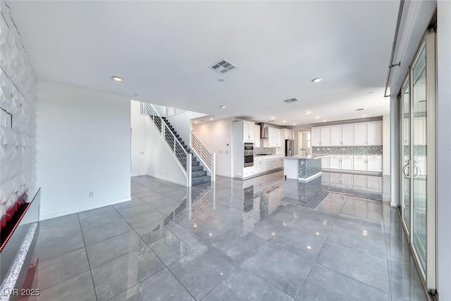 1038 Delbrook Ave, Henderson, NV 89012 - unfurnished living room with stairs, recessed lighting, a sink, and tile patterned flooring