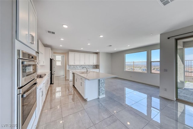 1038 Delbrook Ave, Henderson, NV 89012 - kitchen featuring a sink, stainless steel appliances, light countertops, white cabinets, and recessed lighting