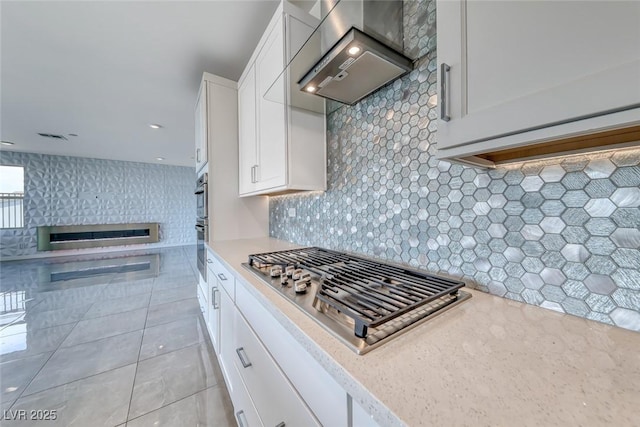 1038 Delbrook Ave, Henderson, NV 89012 - kitchen with ventilation hood, stainless steel gas cooktop, white cabinetry, and tasteful backsplash