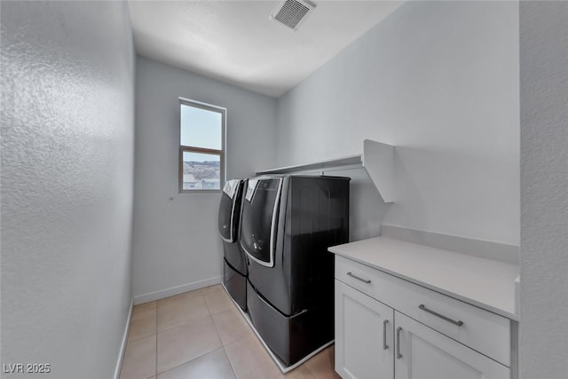 1038 Delbrook Ave, Henderson, NV 89012 - washroom featuring separate washer and dryer, baseboards, light tile patterned flooring, and cabinet space