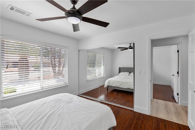 2250 Bowie Cir, Henderson, NV 89014 - bedroom featuring a closet, multiple windows, wood finished floors, and baseboards