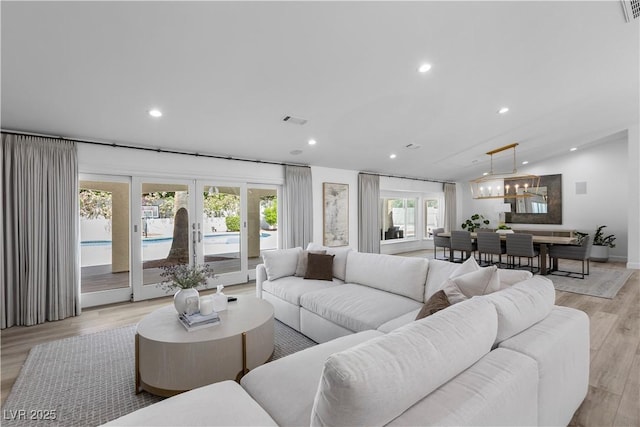 2250 Bowie Cir, Henderson, NV 89014 - living room featuring light wood-style flooring, recessed lighting, french doors, and lofted ceiling