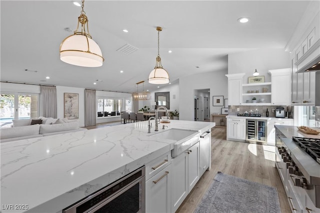 2250 Bowie Cir, Henderson, NV 89014 - kitchen featuring beverage cooler, a sink, open floor plan, open shelves, and lofted ceiling