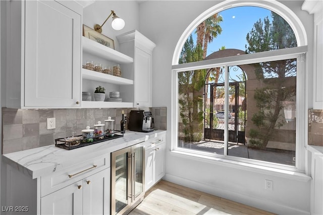 2250 Bowie Cir, Henderson, NV 89014 - kitchen featuring wine cooler, open shelves, plenty of natural light, and tasteful backsplash