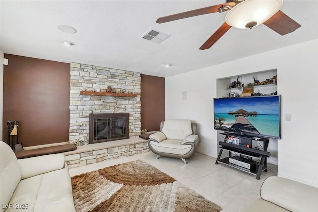 1912 Parkchester Dr, Las Vegas, NV 89108 - living area with a fireplace, ceiling fan, tile patterned flooring, and baseboards