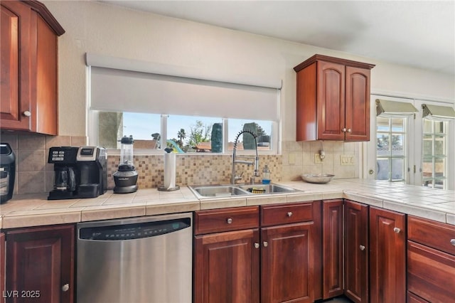 1912 Parkchester Dr, Las Vegas, NV 89108 - kitchen featuring dishwasher, a sink, backsplash, and plenty of natural light