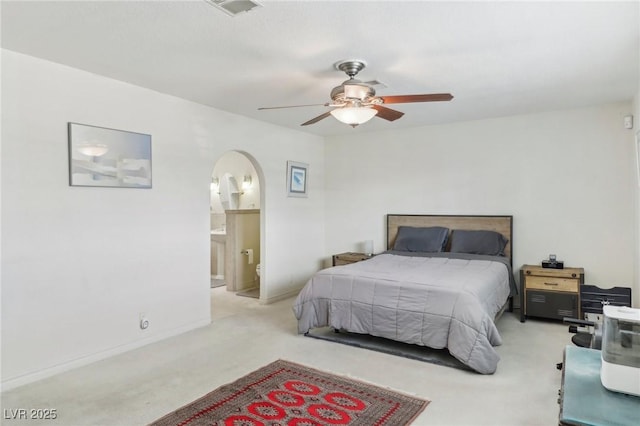 1912 Parkchester Dr, Las Vegas, NV 89108 - bedroom with light carpet, arched walkways, ensuite bathroom, and baseboards