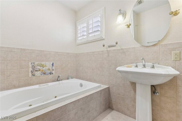 1912 Parkchester Dr, Las Vegas, NV 89108 - full bathroom featuring a whirlpool tub and tile walls