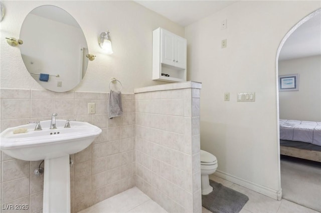 1912 Parkchester Dr, Las Vegas, NV 89108 - ensuite bathroom with tile patterned flooring, toilet, and tile walls