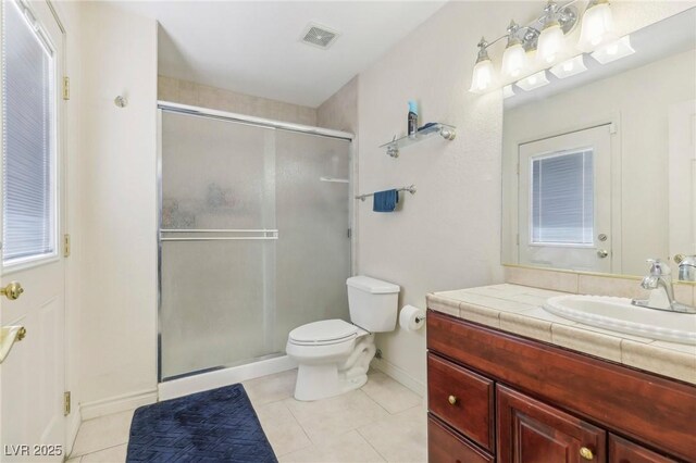 1912 Parkchester Dr, Las Vegas, NV 89108 - bathroom with vanity, a stall shower, toilet, and baseboards
