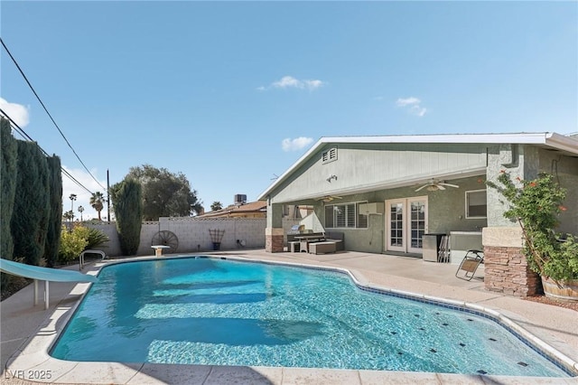 1912 Parkchester Dr, Las Vegas, NV 89108 - view of pool with a water slide, a ceiling fan, a patio area, and a fenced backyard