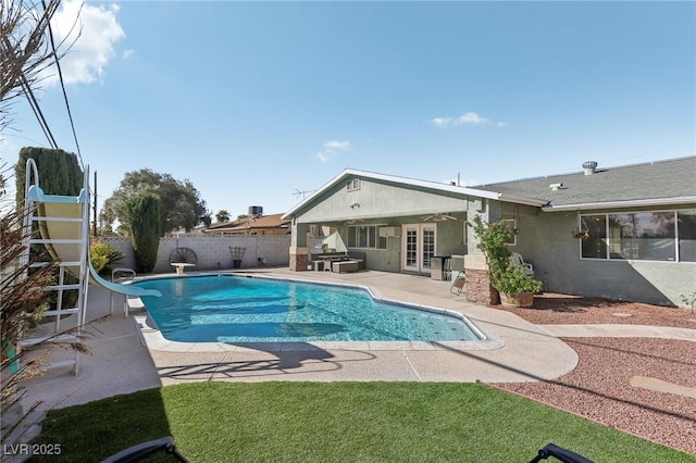 1912 Parkchester Dr, Las Vegas, NV 89108 - view of pool featuring french doors, a patio area, a water slide, and a fenced backyard