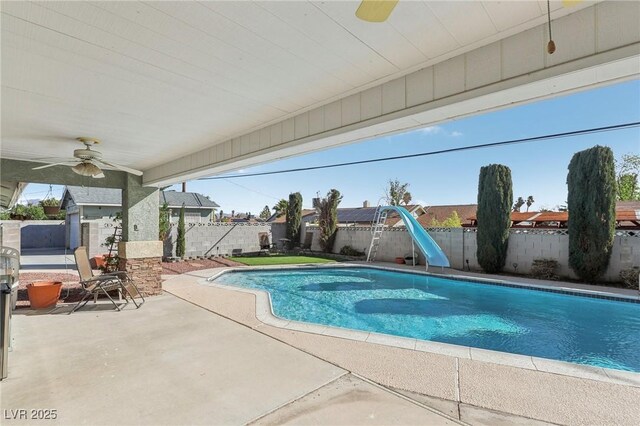 1912 Parkchester Dr, Las Vegas, NV 89108 - view of swimming pool featuring a water slide, ceiling fan, a fenced backyard, and a patio area