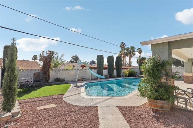 1912 Parkchester Dr, Las Vegas, NV 89108 - view of pool with a water slide, a patio area, and a fenced backyard