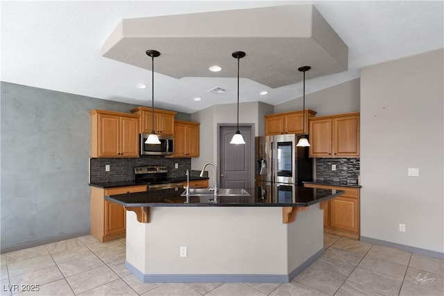 854 Santa Maria Way, Mesquite, NV 89027 - kitchen with appliances with stainless steel finishes, a sink, tasteful backsplash, an island with sink, and pendant lighting