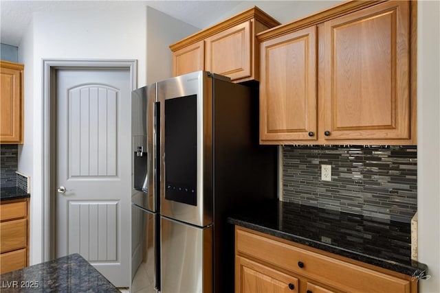 854 Santa Maria Way, Mesquite, NV 89027 - kitchen with stainless steel fridge with ice dispenser, decorative backsplash, and dark stone counters
