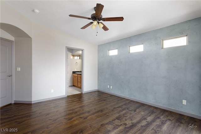 854 Santa Maria Way, Mesquite, NV 89027 - empty room with wood finished floors, ceiling fan, a smoke detector, baseboards, and arched walkways