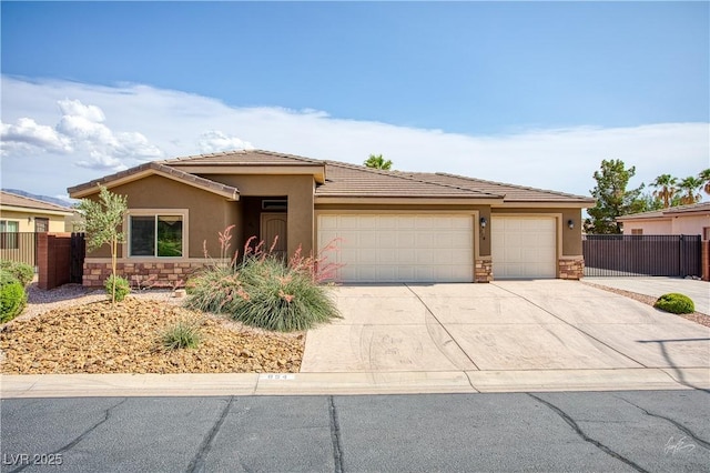 854 Santa Maria Way, Mesquite, NV 89027 - view of front of home with stone siding, stucco siding, a garage, driveway, and a tiled roof
