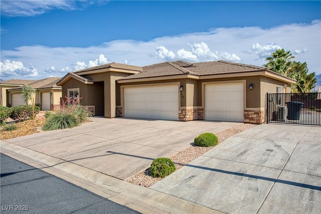 854 Santa Maria Way, Mesquite, NV 89027 - view of front facade featuring stone siding, stucco siding, a garage, concrete driveway, and a tile roof