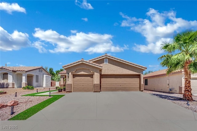 2558 Wiltshire Ave, Henderson, NV 89052 - view of front facade featuring a garage, driveway, and stucco siding